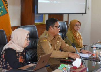 Pj Wali Kota Sukabumi, Kusmana Hartadji, memberikan sambutan dalam sosialisasi dan koordinasi penguatan kolaborasi pengelolaan sampah di Oproom Balai Kota Sukabumi, pada Senin (16/12/2024).